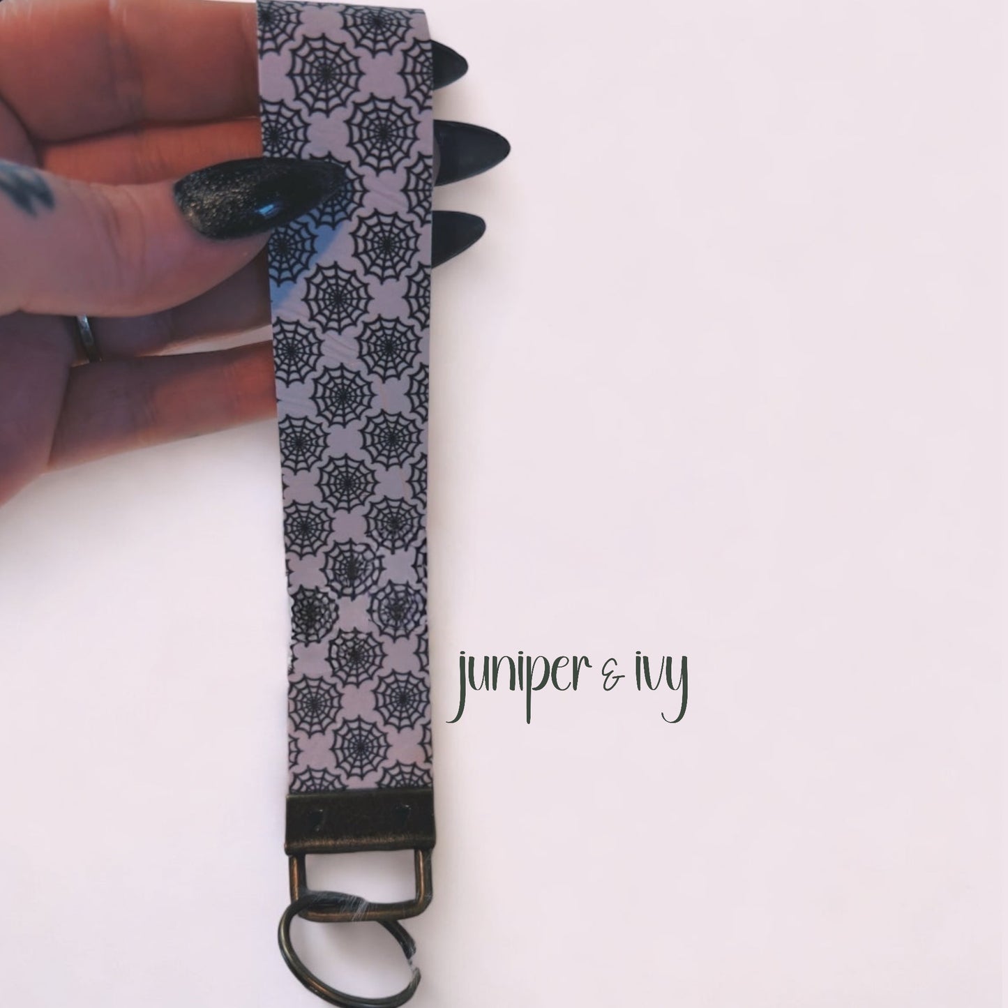 Spiderweb faux leather wristlet