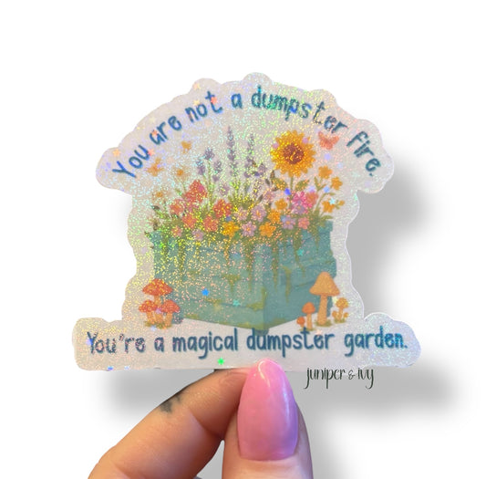 You are not a dumpster fire, you’re a magical dumpster garden holographic sticker
