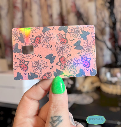 Jack-o’-lantern cherries and cobwebs credit card skin