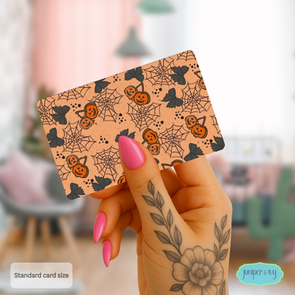 Jack-o’-lantern cherries and cobwebs credit card skin