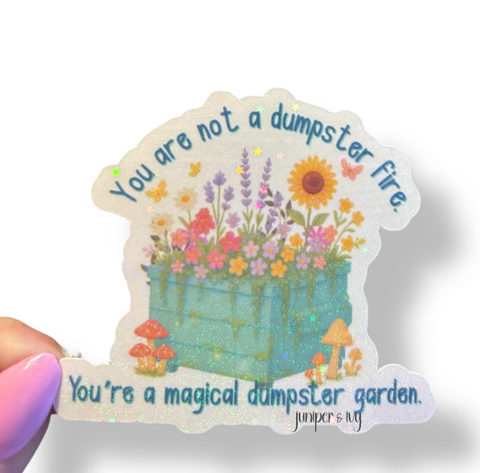 You are not a dumpster fire, you’re a magical dumpster garden holographic sticker