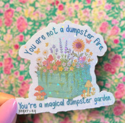 You are not a dumpster fire, you’re a magical dumpster garden holographic sticker